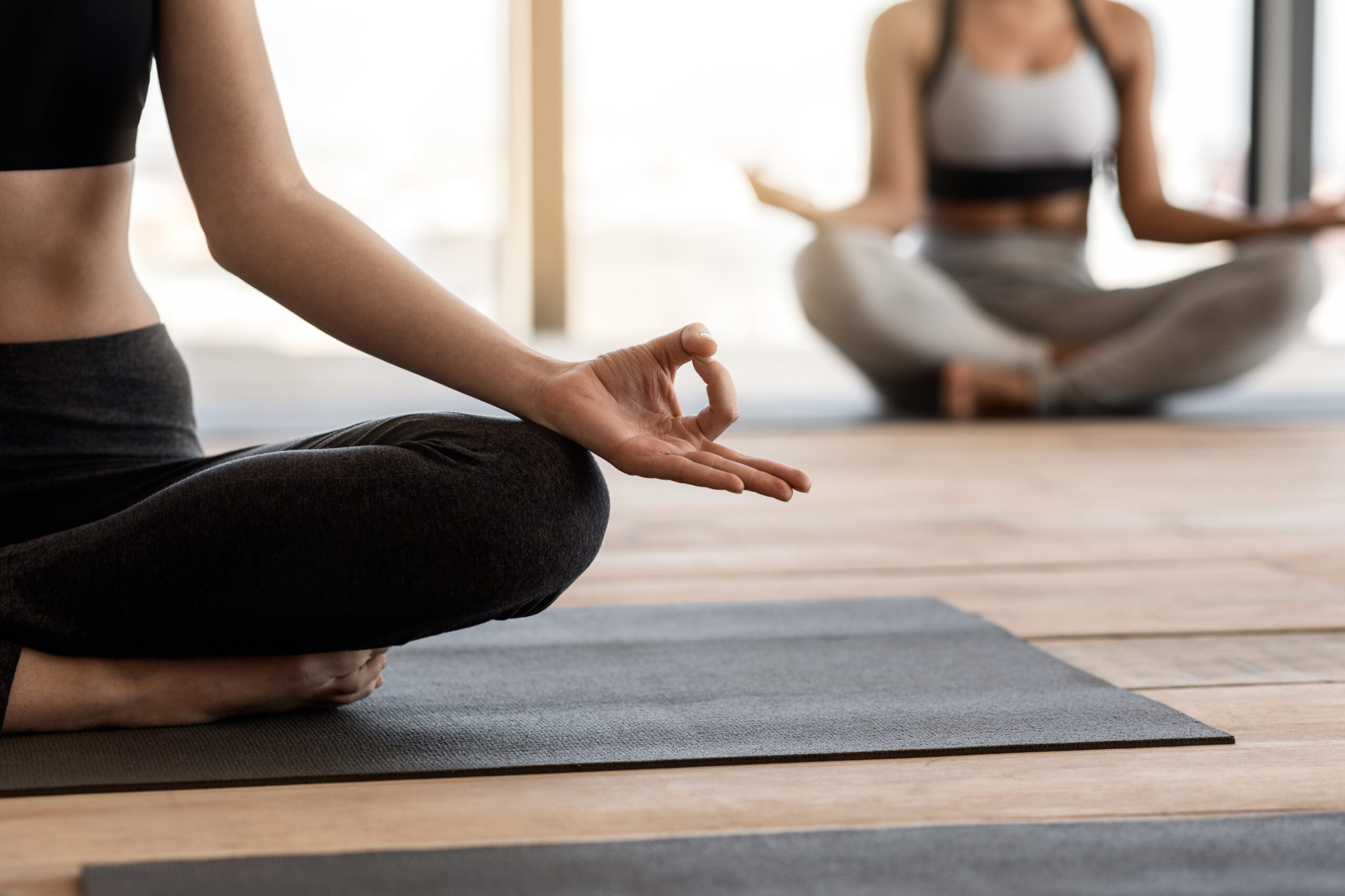 Closeup Of Unrecognizable Female Practicing Yoga At Group Class In Studio